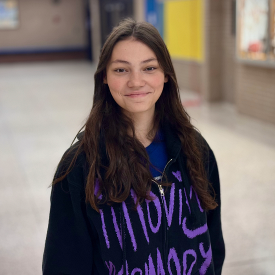 Sophia and judge hold document at her swearing in ceremony